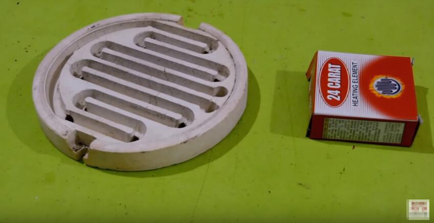 切开塑料桶并装入电热圈，用它刚洗的衣服也能快速烘干