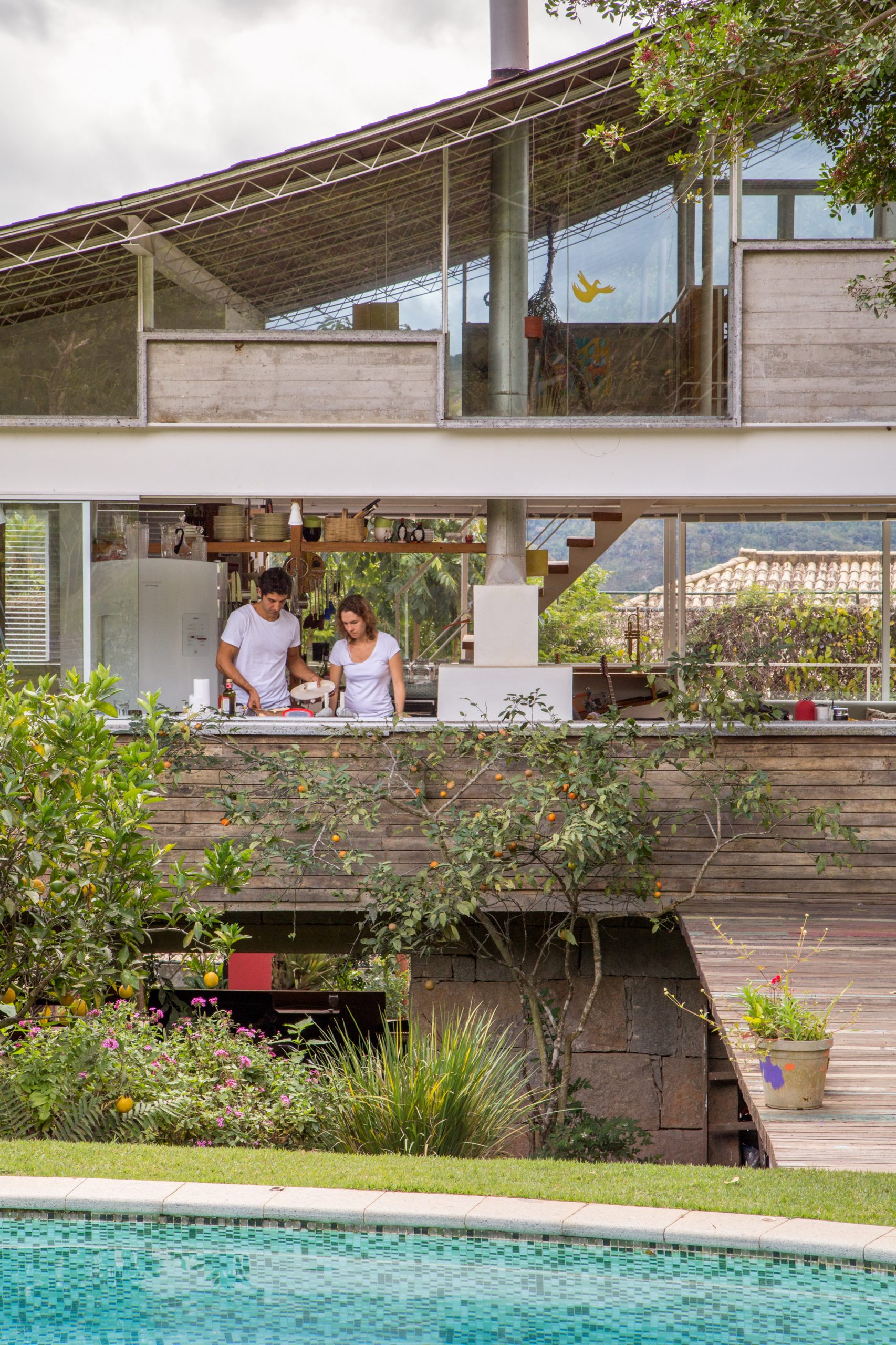 山林环绕的建筑师自宅，有着大坡屋顶和大圆泳池的玻璃房子