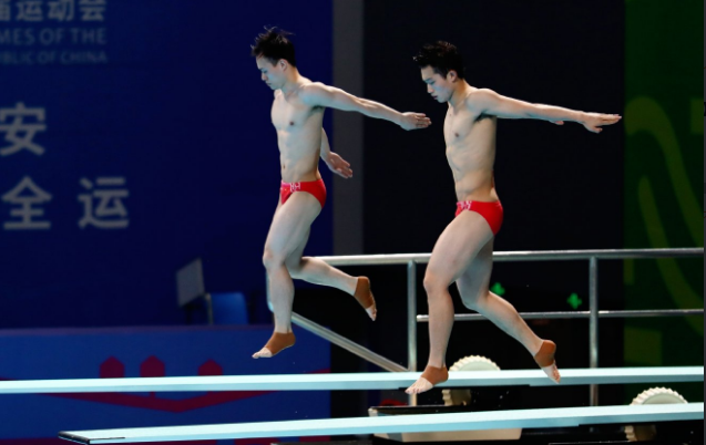 全红婵现身看台！目睹国家队师哥夺冠，戴卡通口罩，专注玩手机