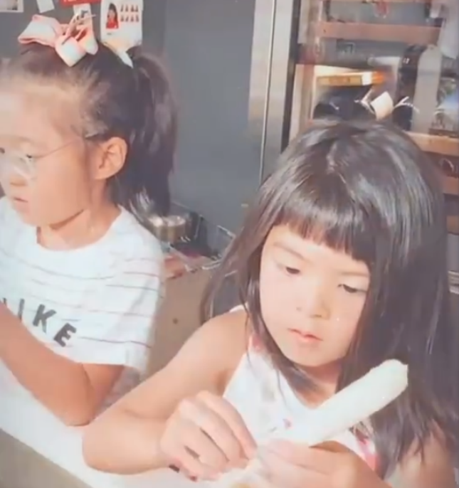 贾静雯两女儿在家洗菜，咘咘蝴蝶结造型养眼，哪知妹妹更抢镜