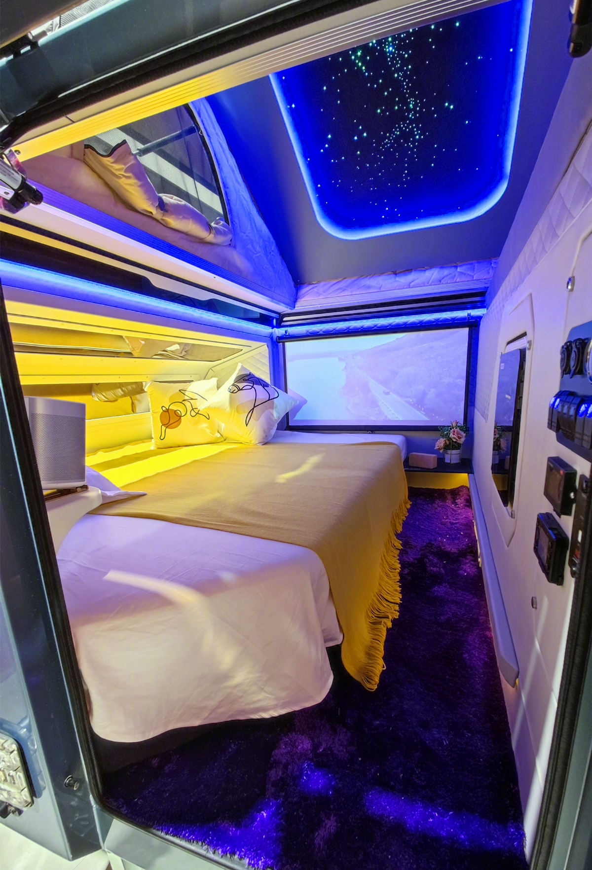 体内还配备了一张柔软的双人床,搭配推拉式车顶帐篷,氛围灯以及星空顶