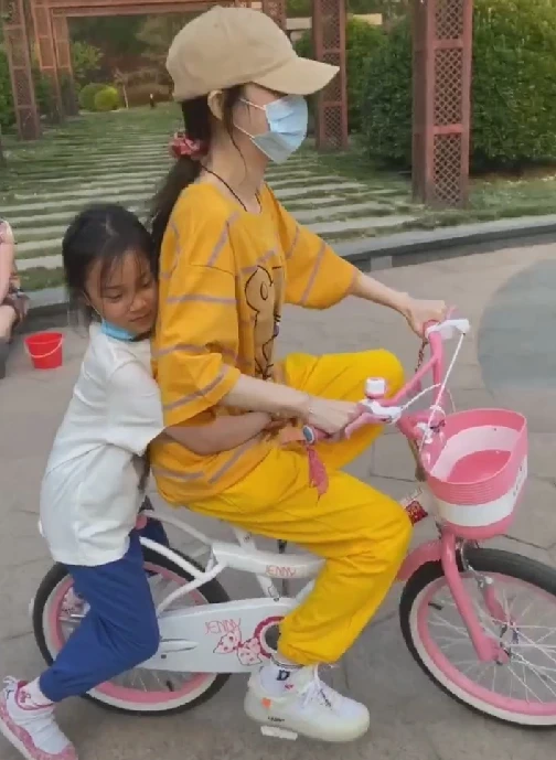 7岁甜馨相当独立，街头骑单车又美又飒，使劲抬